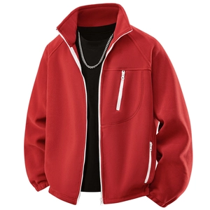 Detail of red fleece jacket featuring white contrast zippers and textured warm fabric