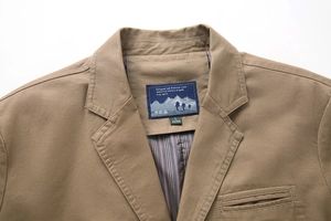 Detail of notch lapel and stitching on men's khaki cotton business casual blazer jacket