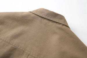 Detailed close-up of stitching on khaki cotton business casual blazer back shoulder
