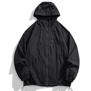 Close-up of black sun protection jacket featuring micro-pleated fabric and zipper details