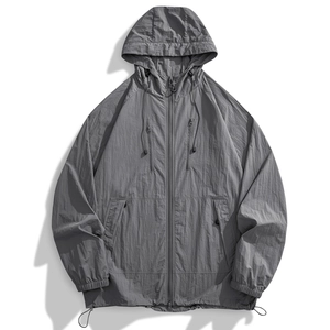 Detailed macro view of gray sun protection jacket showing technical nylon fiber texture