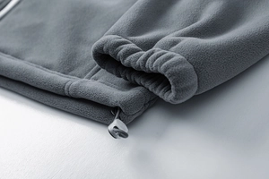 Detail of high-density fleece jacket showing elastic cuff and adjustable drawstring hem