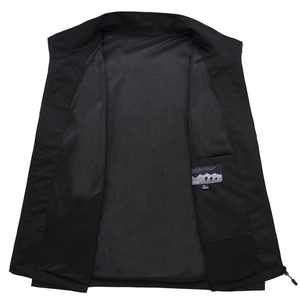 Detail of black outdoor vest showing breathable mesh lining and inner pocket with size tag
