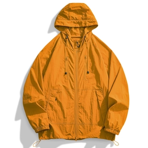 Detail of an orange hooded sun protection jacket with zip pockets and textured nylon fabric