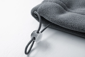 Detail of gray fleece jacket featuring elastic drawstring with transparent plastic cord lock