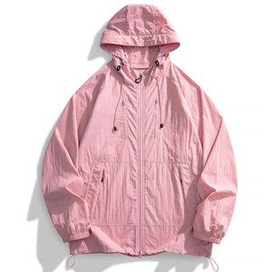 Detail of pink hooded sun protection jacket with zip pockets and textured nylon fabric