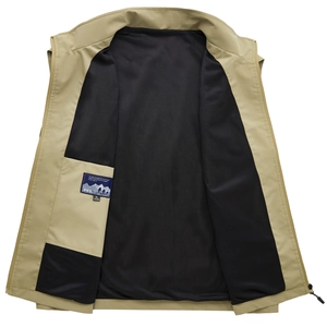 Detail of khaki outdoor vest showing black mesh lining, inner pocket, and brand label