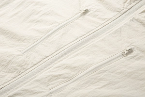 Close-up of high-quality nylon sun protection jacket with smooth zippers and fabric texture