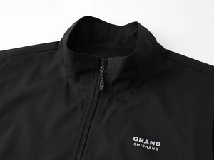 Detail of windproof stand collar vest featuring matte fabric and silver logo print