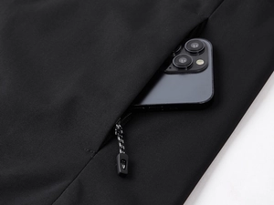 Close-up of black windproof vest side pocket with zipper and smartphone storage space