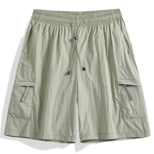 Relaxed fit light sage green cargo shorts with elastic drawstring waist and side pockets