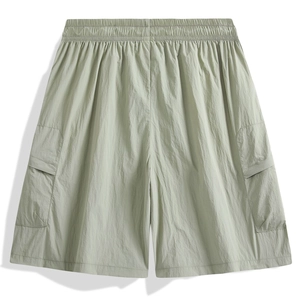 Detailed view of sage green cargo shorts with elastic waist and textured fabric