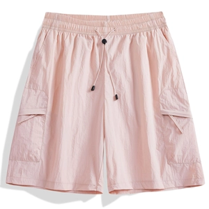 Detail of light pink cargo shorts featuring drawstring elastic waist and side flap pockets