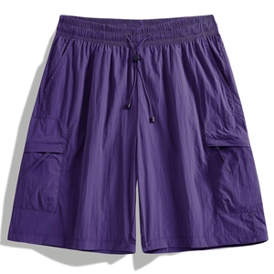 Detail showing elastic waist with drawstring and flap cargo pockets on purple shorts