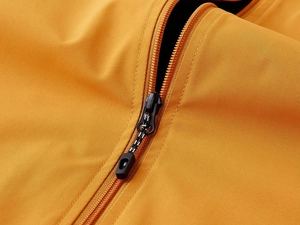 Detail of windproof outdoor vest showing resin zipper and breathable mesh lining