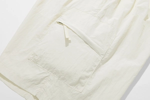 Detail of loose casual shorts featuring breathable fabric and functional cargo pockets