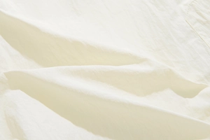 Detailed macro view of lightweight breathable nylon fabric and stitching on casual shorts
