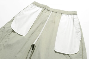 Detail view of quick-dry shorts with white mesh pockets and elastic drawstring waist