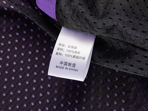 Détail de l'étiquette de lavage et du tissu en maille respirante de la veste