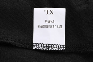 Detail view of the black sports shorts fabric label showing 95% polyester and size XL