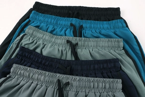 Detail view of elastic waistbands and adjustable drawstrings on multi-color sports shorts