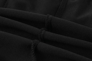 Detailed close-up of breathable black sports fabric with durable hemmed stitching details