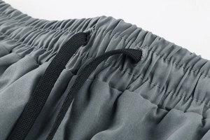 Close-up of high-elastic waistband with black drawstrings on breathable sports shorts