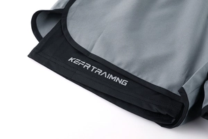 Detailed close-up of double-layer sports shorts with grey fabric and printed liner