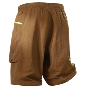 Detail view of brown cargo shorts featuring cargo pocket with yellow accent and elastic waistband