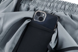 Detail of athletic shorts with built-in phone pocket and elastic drawstring waistband