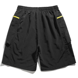 Detail of men's cargo shorts featuring elastic waistband and yellow side stripes