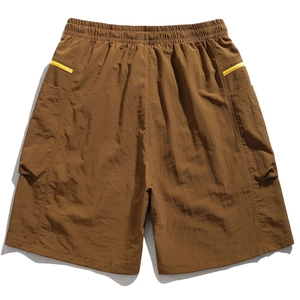 Detail of brown cargo shorts featuring an elastic waistband and side patch pockets