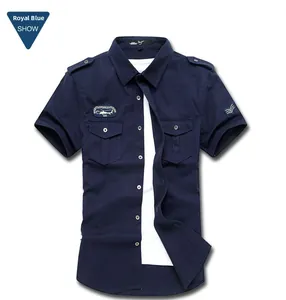 Detailed close-up of dark blue military style short sleeve shirt with epaulets and chest pockets