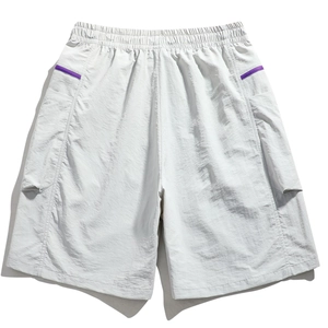 Detail of light gray summer cargo shorts with elastic waist and purple pocket trim