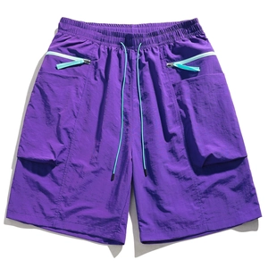 Detail showing elastic waistband with light blue drawstring and pockets on purple cargo shorts