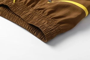 Detailed macro view of elastic waistband and zipper pocket on brown cargo shorts