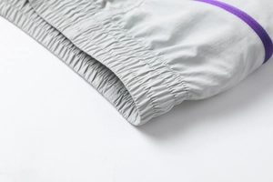 Close-up of quick-dry shorts leg opening with purple piping trim and elastic stitching