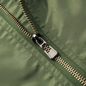 Close-up of military green jacket showing high-quality metal zipper and nylon twill fabric