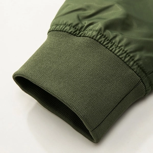 Close-up of military green flight jacket featuring high-density ribbed cuffs and stitching