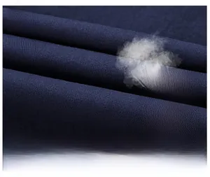 Close-up detail of dark blue breathable washed cotton fabric on men's short sleeve shirt