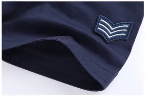 Detail of dark navy cotton shirt showing V-shaped military embroidery and double stitching