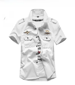 Detail of white military short-sleeve shirt with tactical epaulets and embroidered patches
