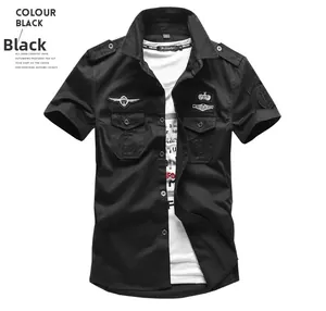 Detail of black military short sleeve shirt with shoulder epaulets and chest embroidery
