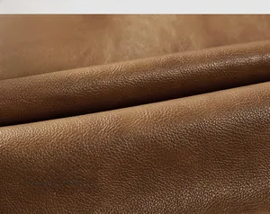 Detailed macro view of the brown lychee-textured PU leather with soft matte finish