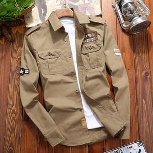 Detail of khaki military style work shirt with epaulets and dual flap chest pockets