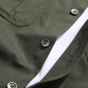 Detail of army green cargo shirt showing reinforced double stitching and metal buttons