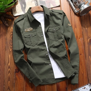 Detailed close-up of army green military style shirt with dual pockets and embroidery