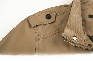 Close-up of khaki cotton jacket showing shoulder epaulettes and ribbed stand collar details