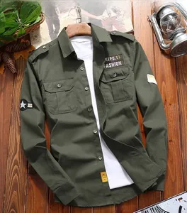 Detailed close-up of military olive green cargo shirt with chest pockets and star patches