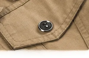 Close-up of durable cotton twill fabric with a round black button and metal trim detailing